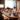 A group of business professionals meeting at a round table with their laptops.